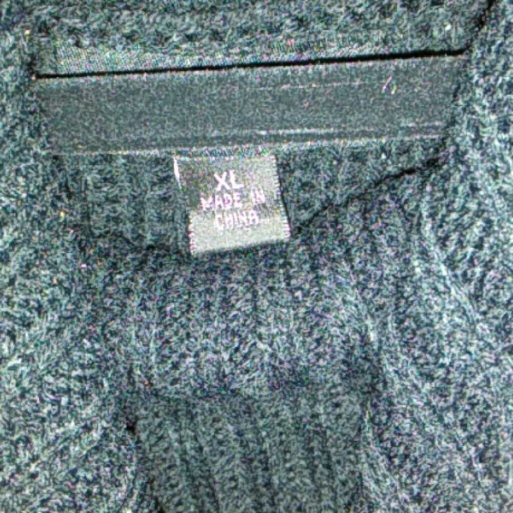 A knitted black dress with leather straps on the s